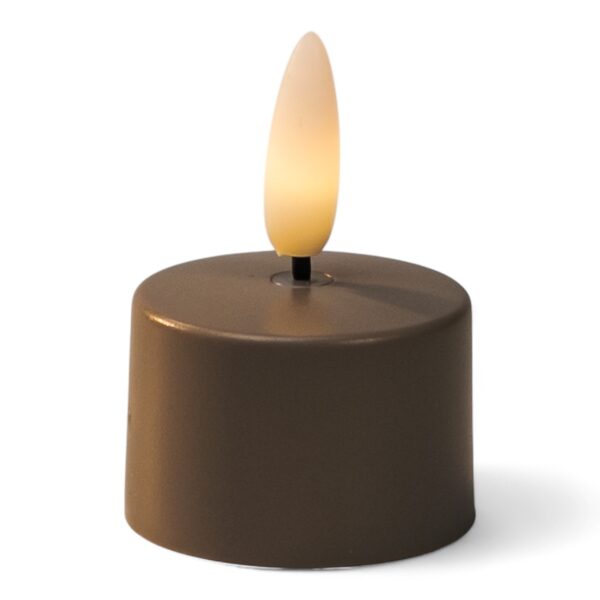 Ett litet brunt batteridrivet LED-värmeljus med en realistisk lågliknande glödlampa som lyser med ett varmgult sken.